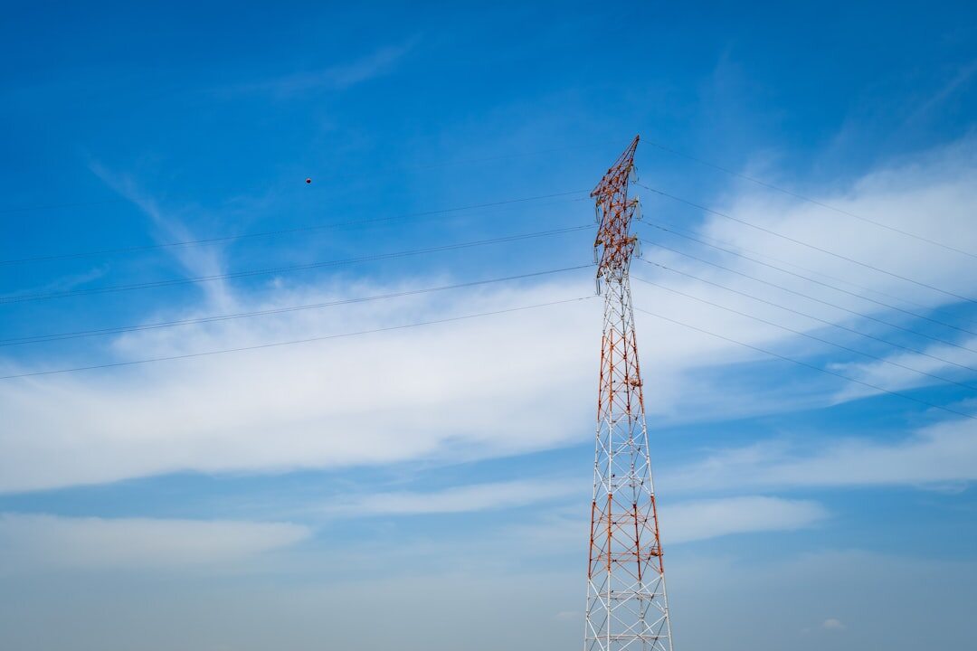 Broadcast antenna tower against a bright sky